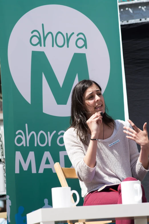 the woman is giving a speech to someone