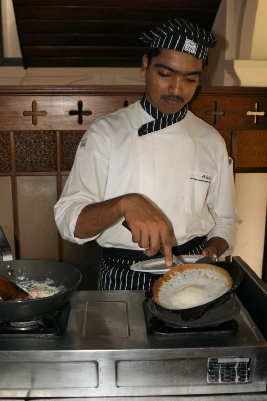 the chef is putting sauce on the pan while cooking food