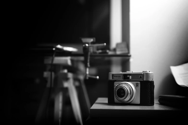 an old analog camera sits on a desk