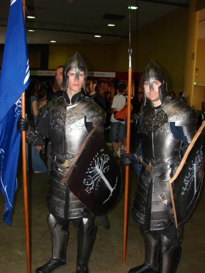 people in armored costumes stand at a event