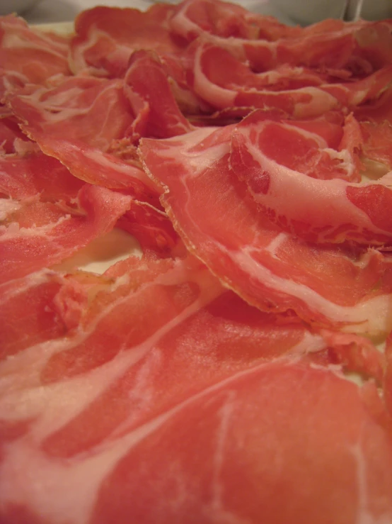 a large plate of raw meat in the center