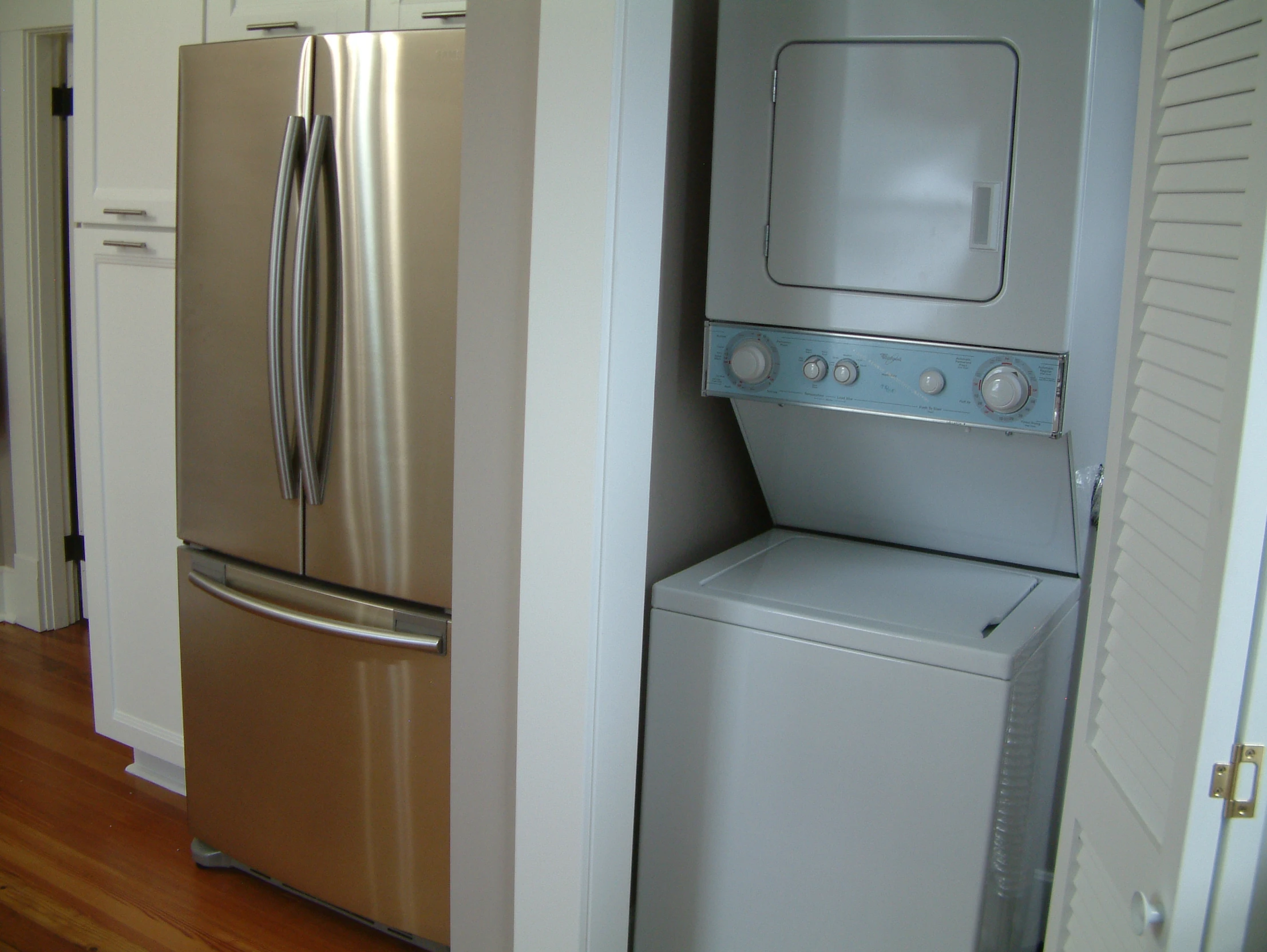 a silver refrigerator freezer sitting inside of a kitchen