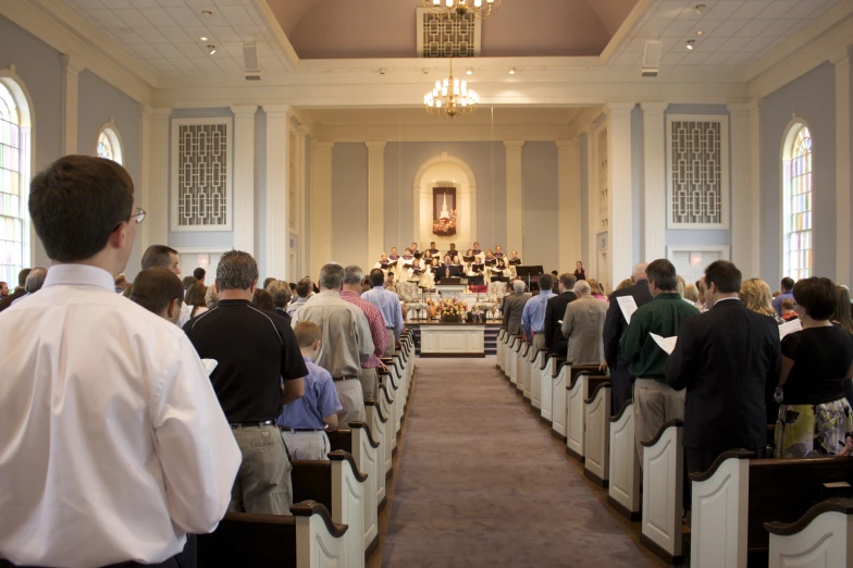 an empty chapel filled with people sitting down for a service