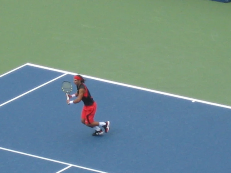 a man on a tennis court with a racquet in hand