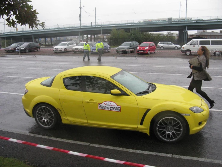 a yellow sports car parked on the side of a road