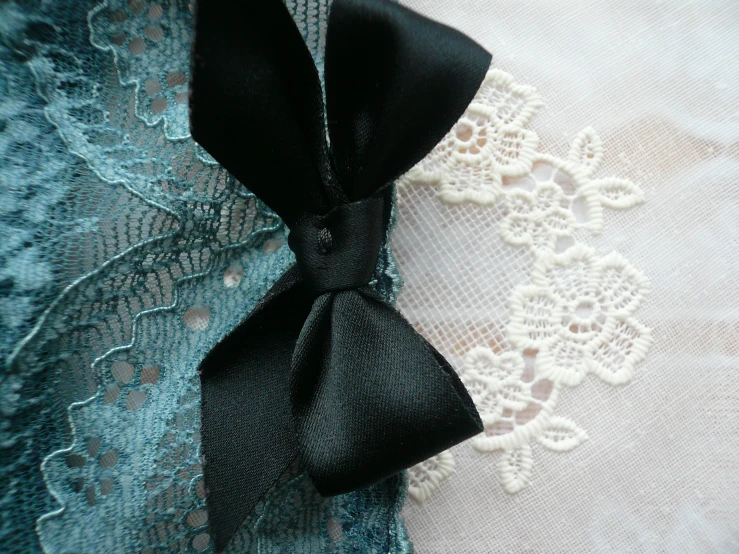 an old fabric with lace, satin bow and ribbon