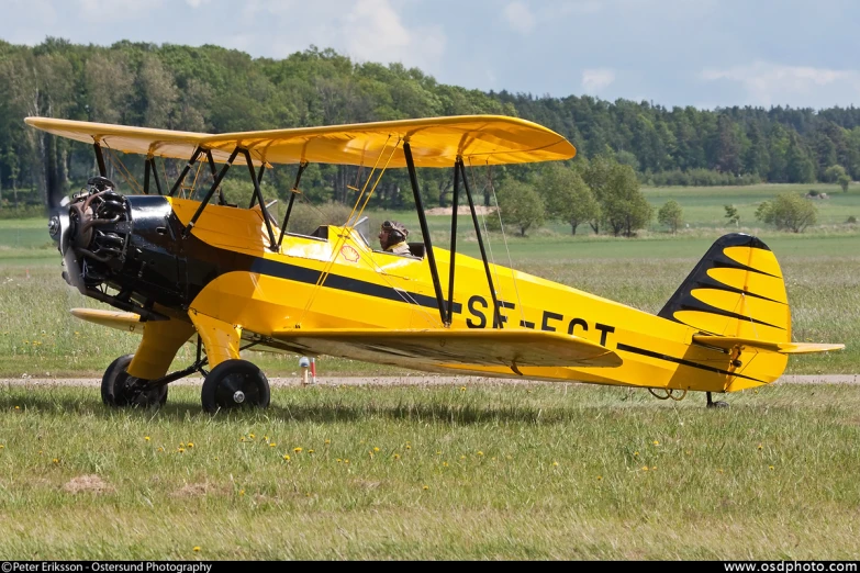 a yellow airplane is parked on the runway