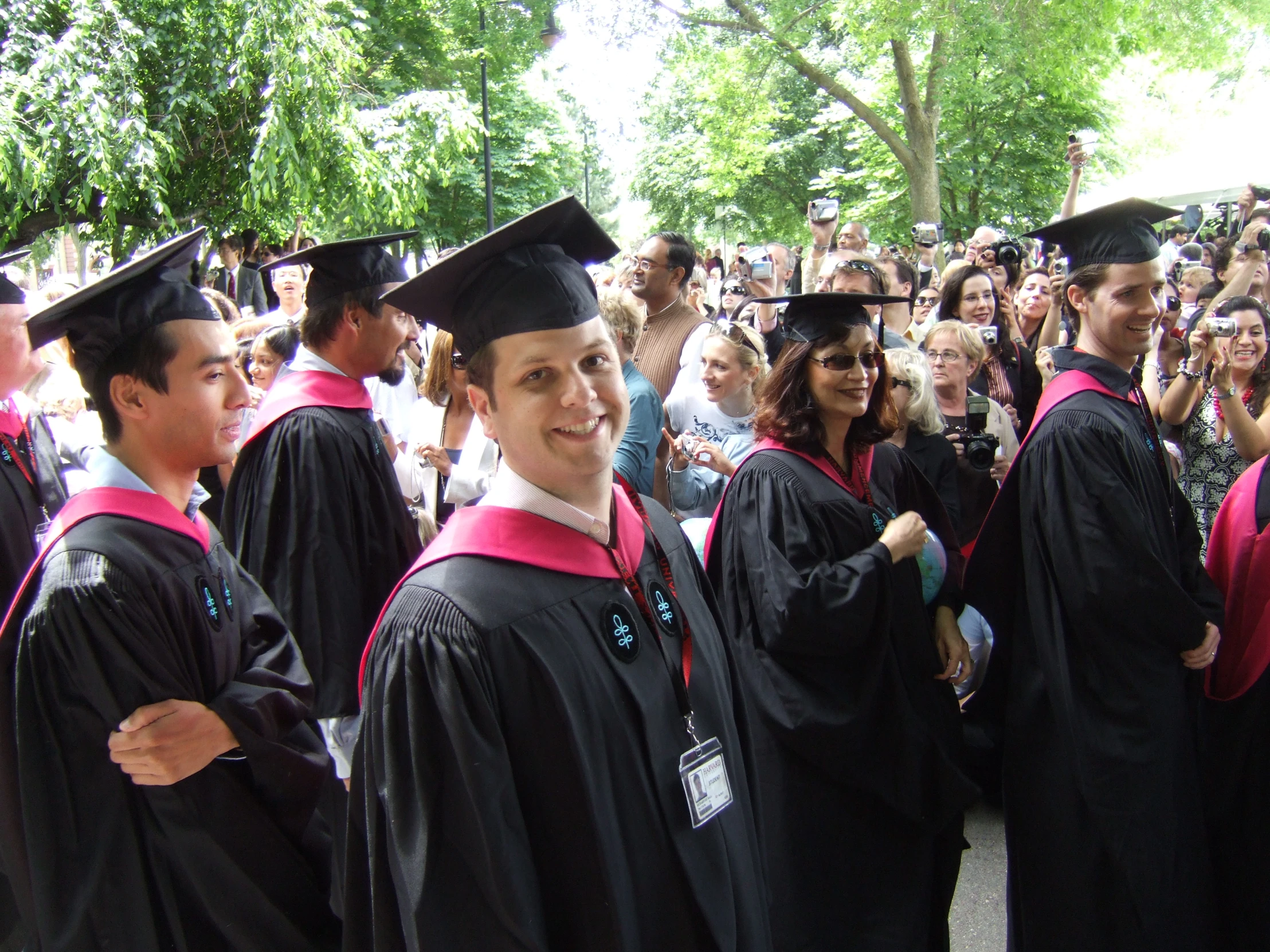 two male students standing next to a group of students