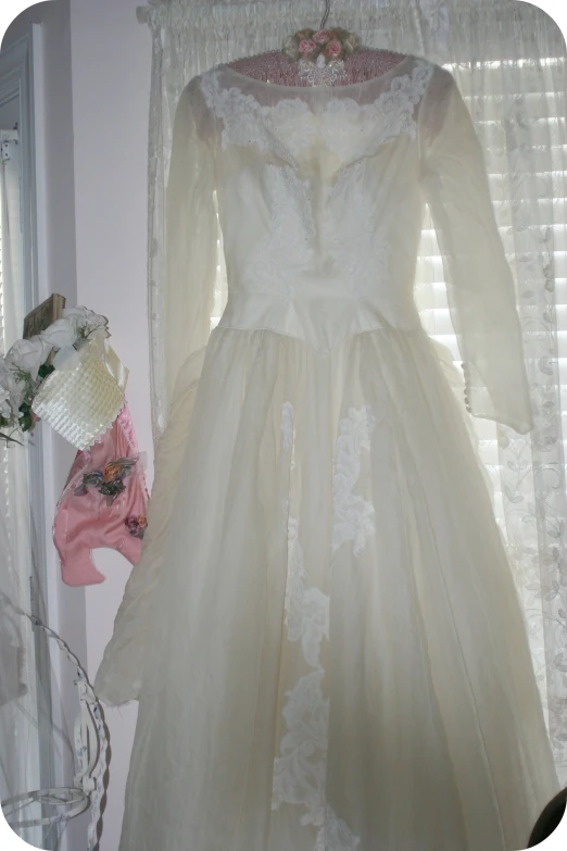 a white dress on display by a window