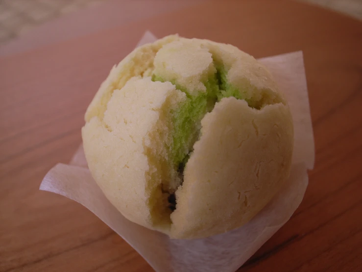 a round pastry sitting on top of wax paper