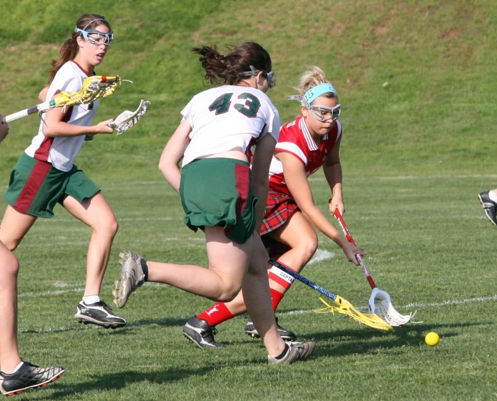 two women playing lacrosse on the field