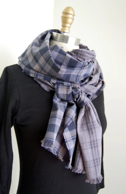 a white and blue plaid scarf on top of a mannequin