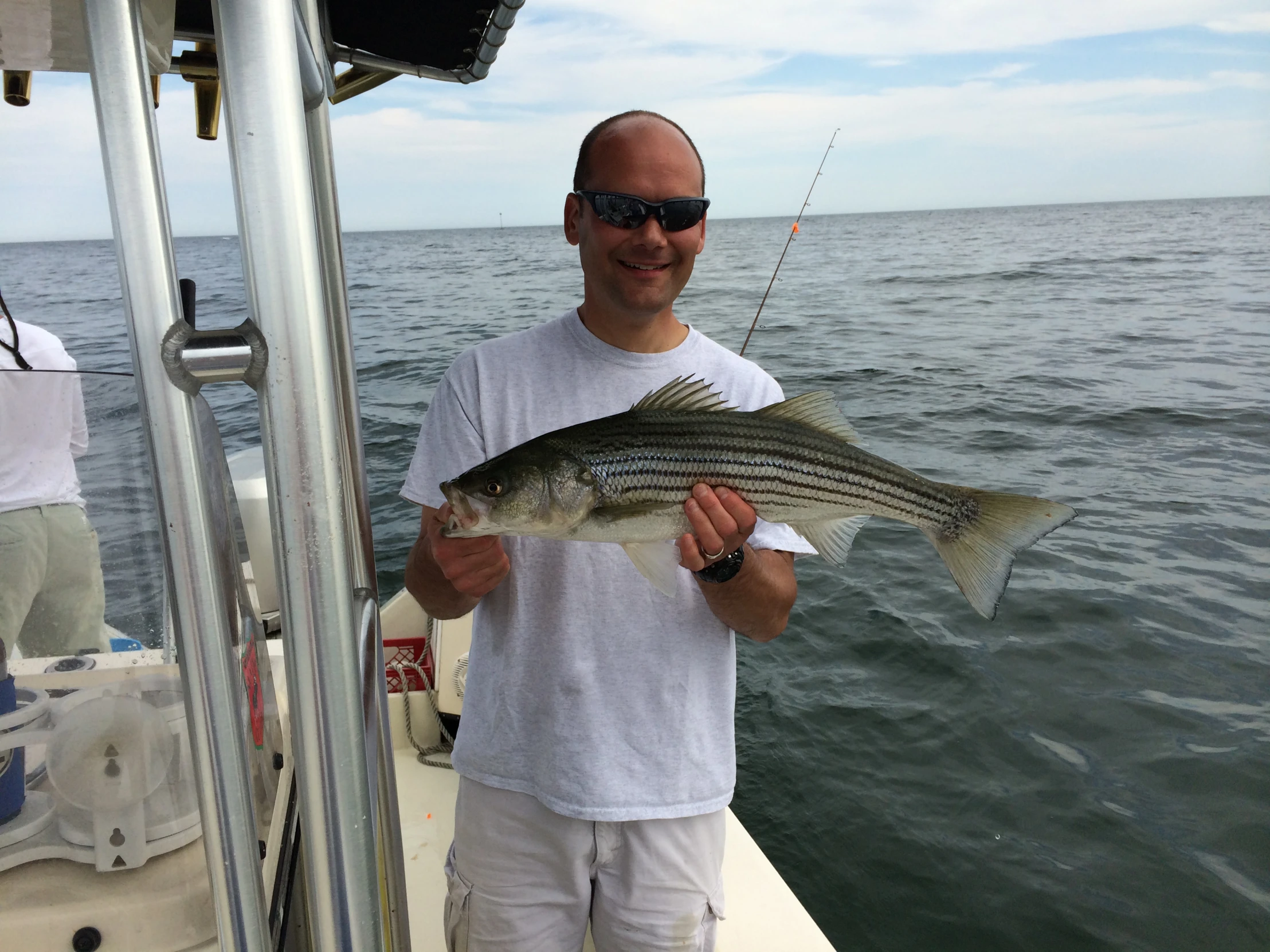 a man is smiling while holding a fish