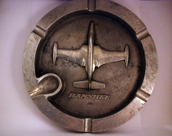 an antique airplane metal plate mounted on a wall