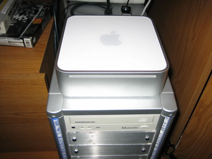 an apple computer tower with a keyboard sitting on top of it