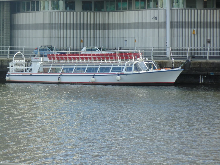 a boat is docked near the curb and building