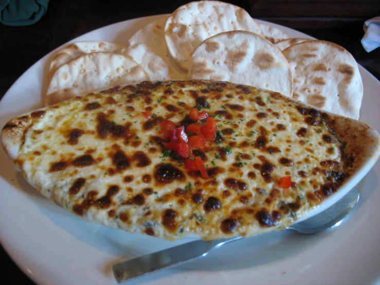 a cheese pizza on a plate with chips