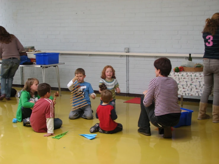 children are playing with a kite in a class