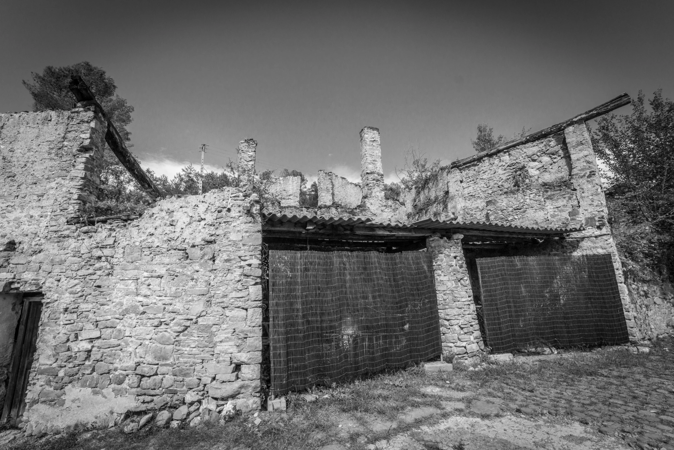 an old brick building with the doors open