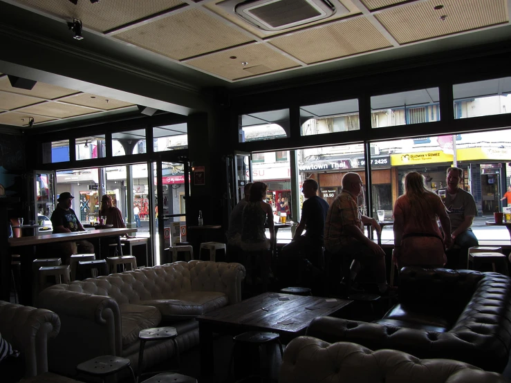 a group of people standing inside of a bar