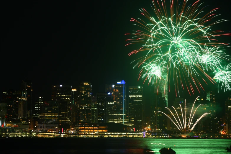 colorful fireworks in the sky over a city at night