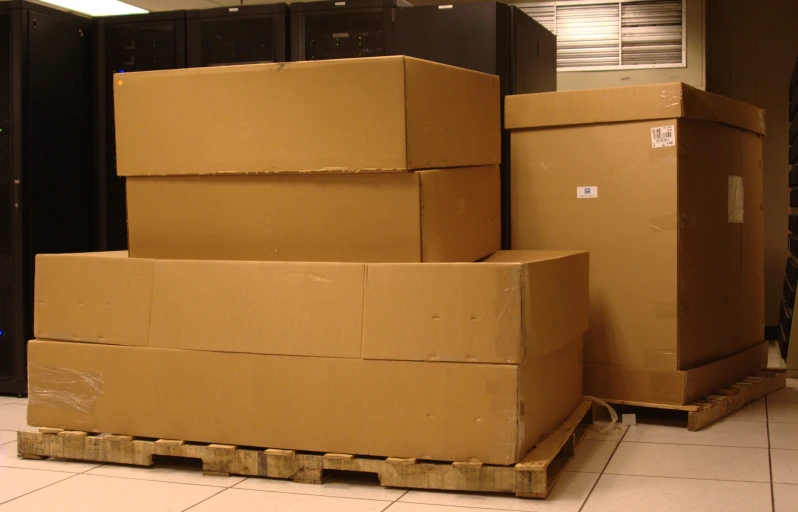 some boxes sitting in a storage room with their tops packed