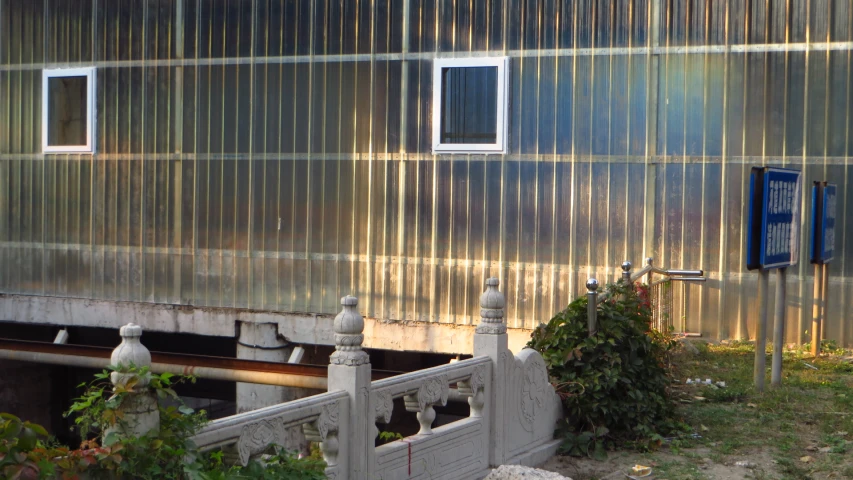 a gray steel building with some window on it