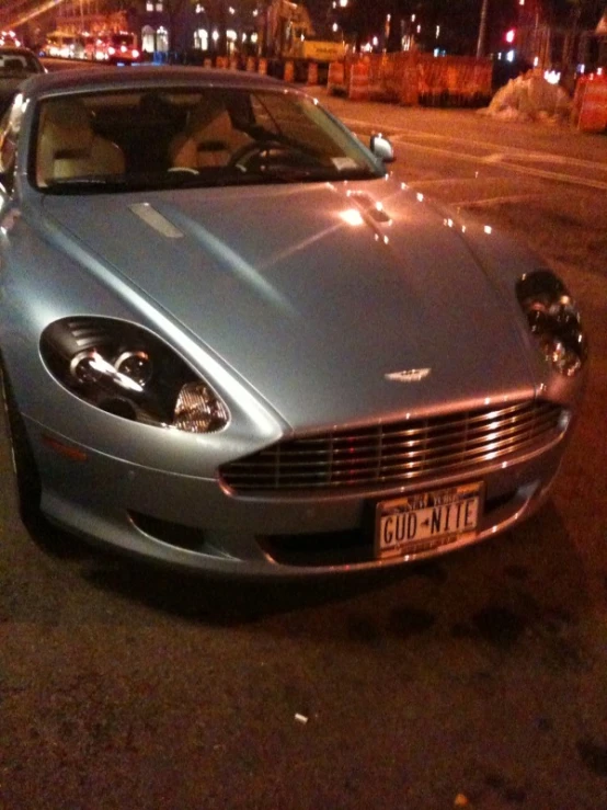 silver and black sports car sitting in parking lot at night