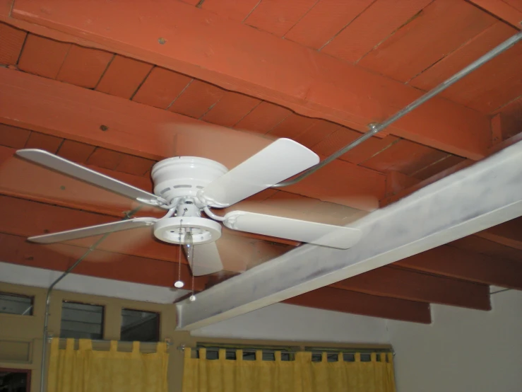 the ceiling fan on top of a white ceiling fan