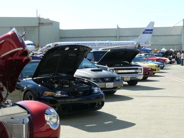 a couple of cars that are in front of a plane