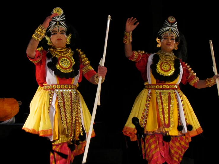 the two women are performing dance on the stage