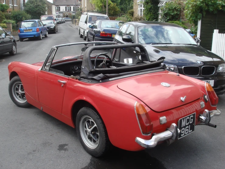 a red sports car is shown parked on the side of the street