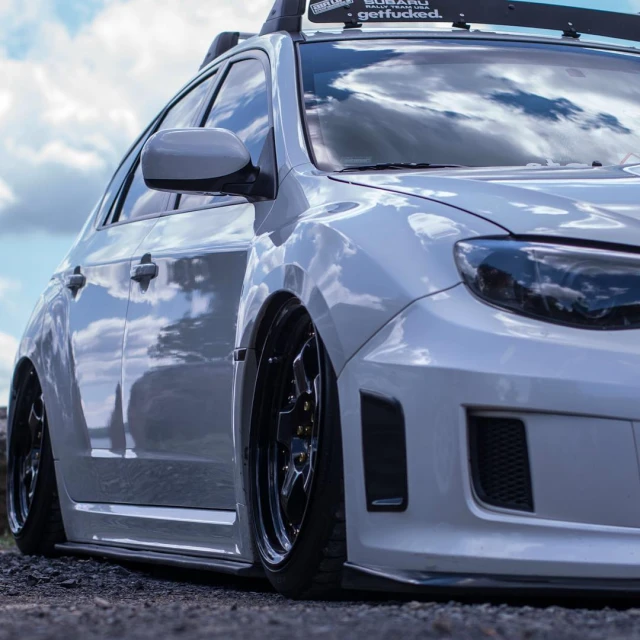 a car that is parked near a grassy field