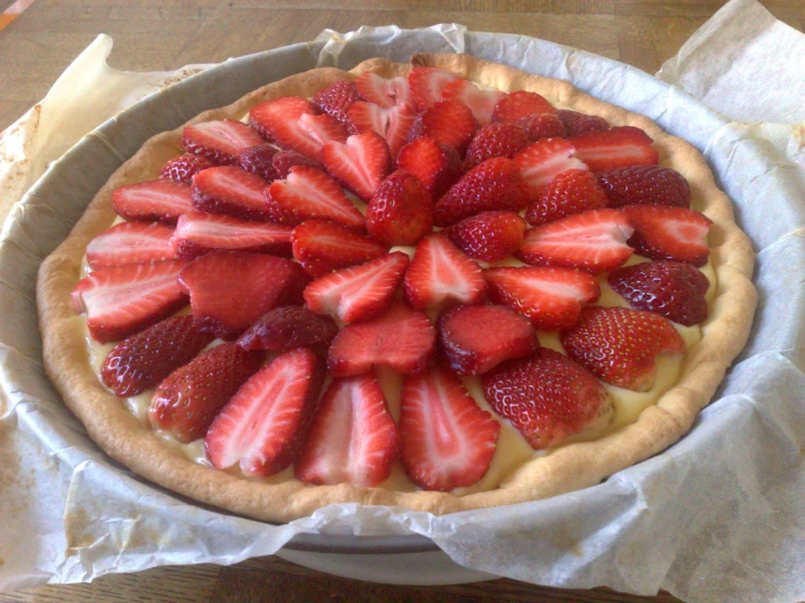 a small pie with sliced strawberries in it