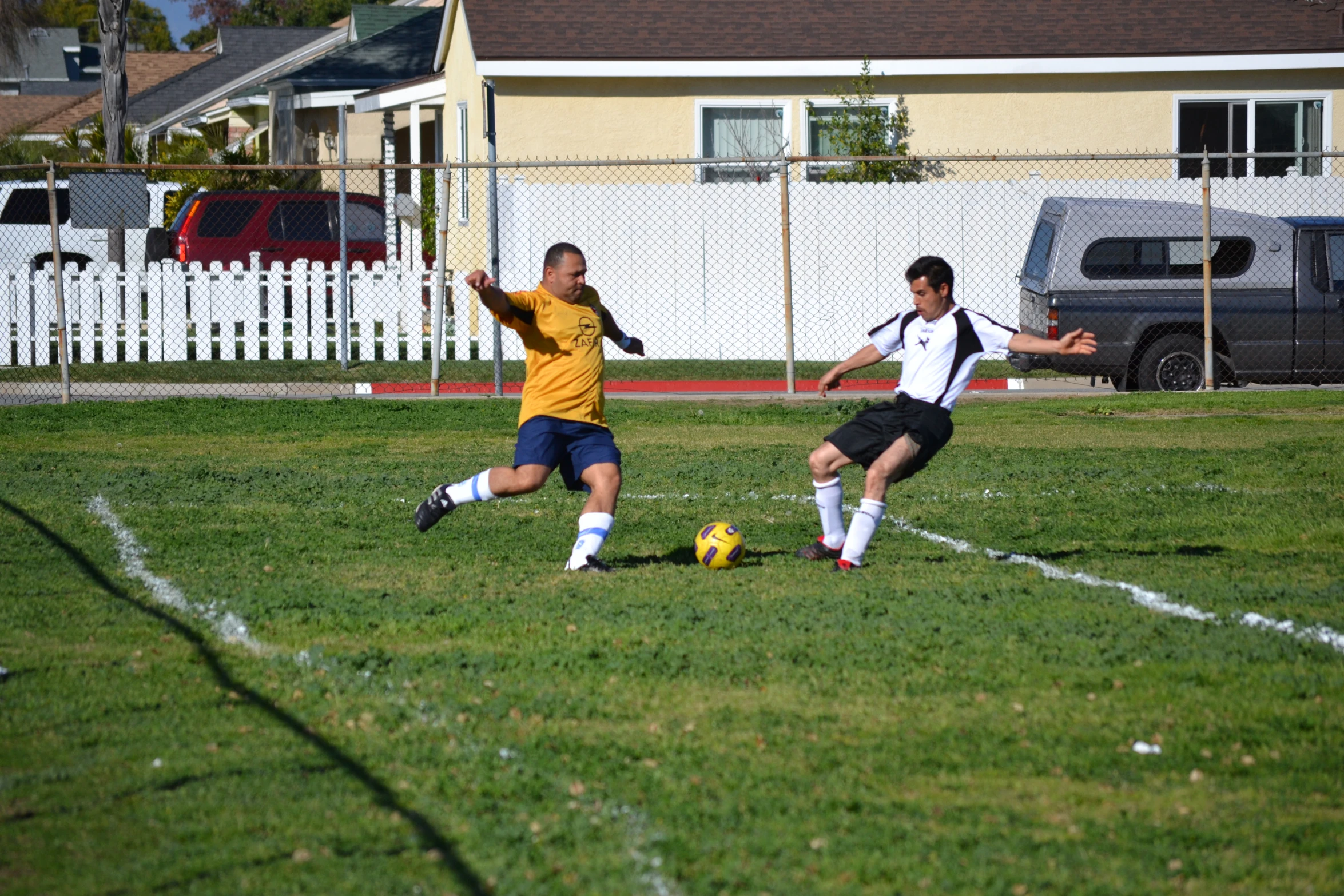 two men on opposite teams playing soccer on the field