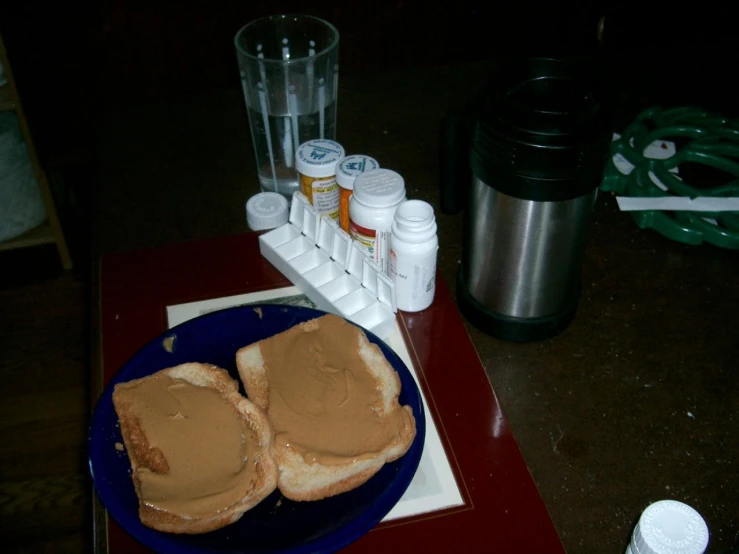 two peanut er sandwich on a plate with pills