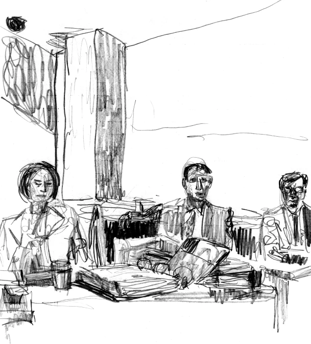 three people sitting at a table and a drawing is drawn on paper