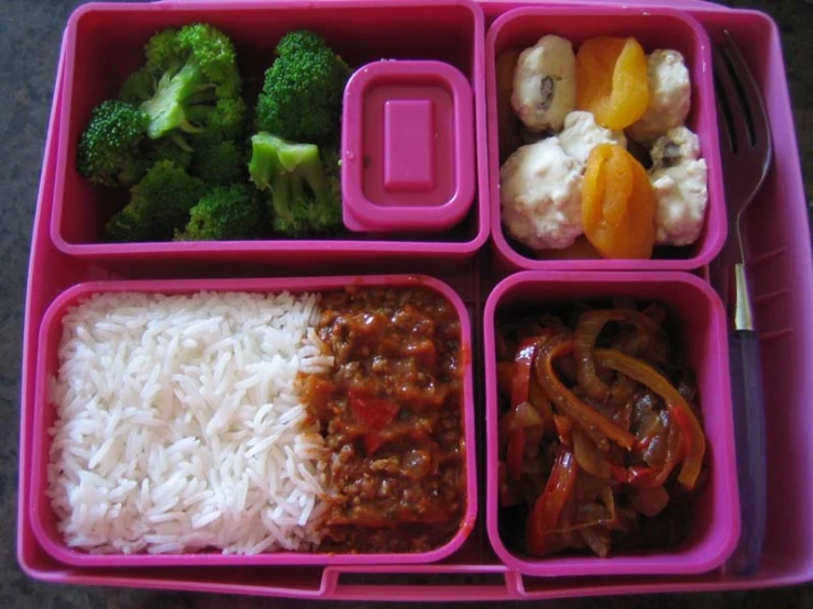 pink lunch box with rice, broccoli and vegetables