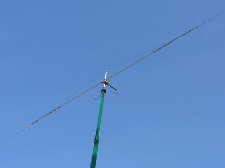 a tower that has two wires and a satellite