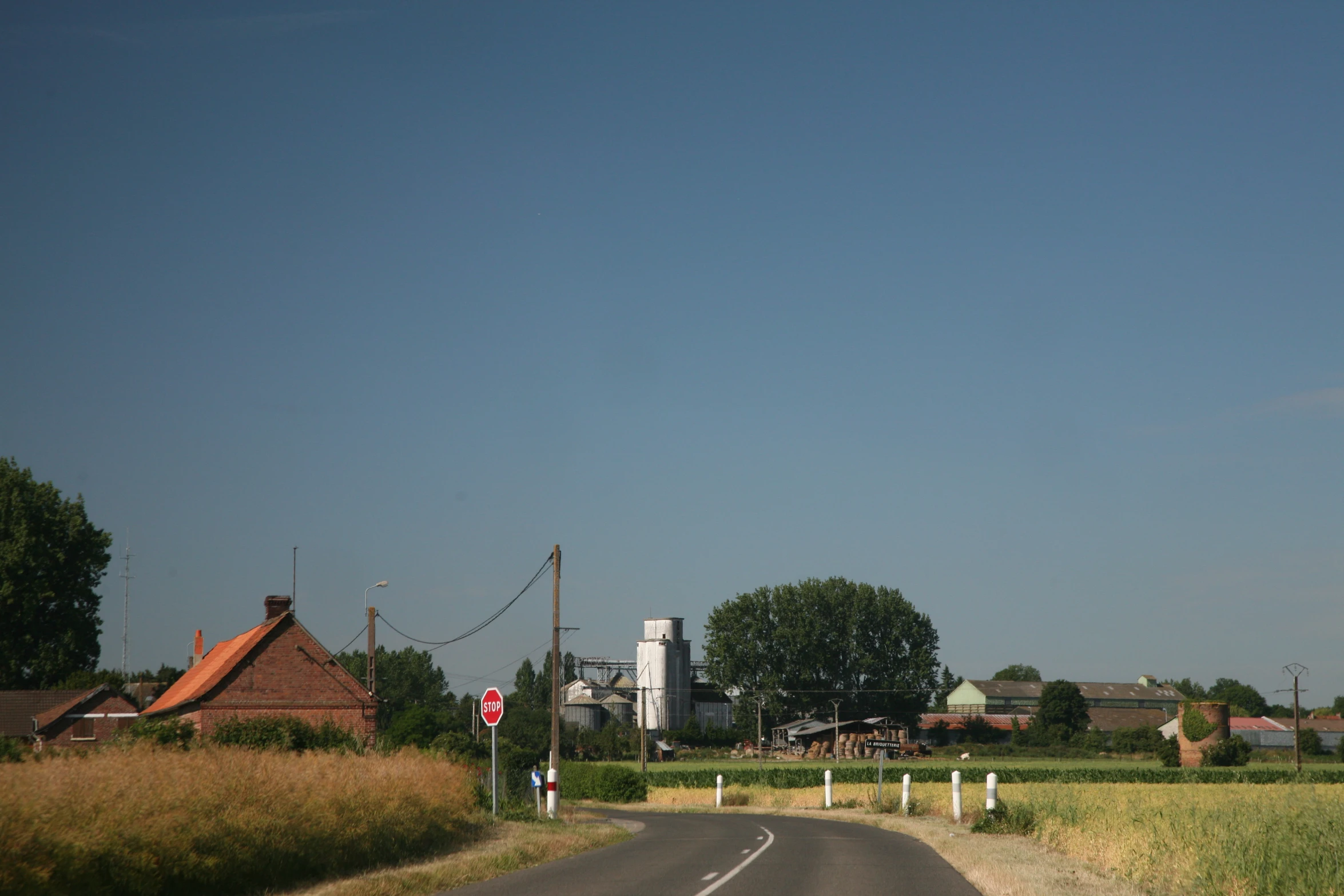 a road that has a stop sign on the side