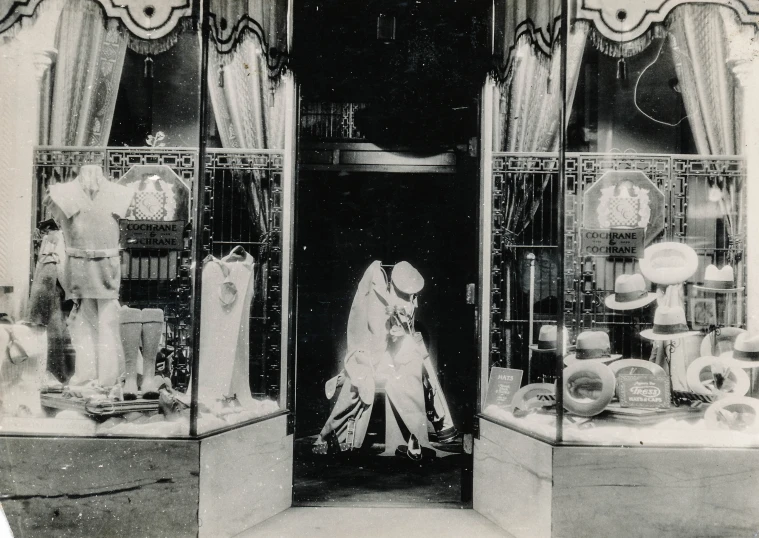 a woman dressed in a wedding veil and standing inside a store front