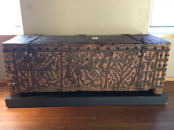 there is an ornately decorated trunk on a stand