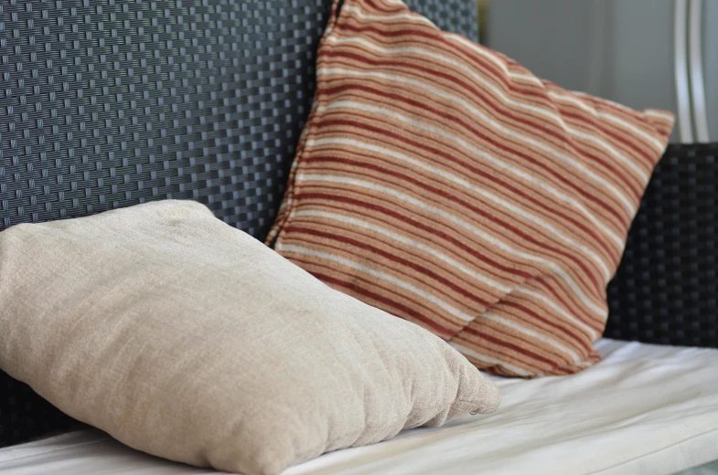 a pillow is lying on top of the headboard of a couch