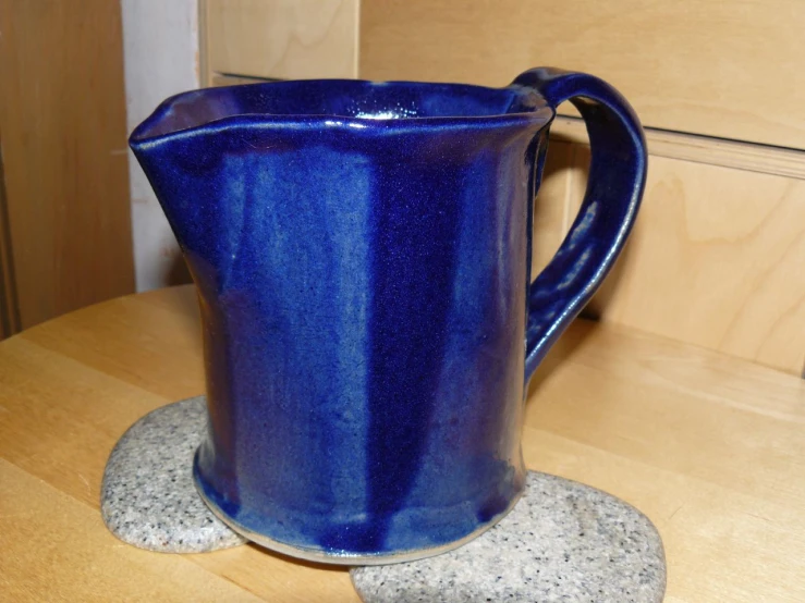 a blue jug is sitting on a table