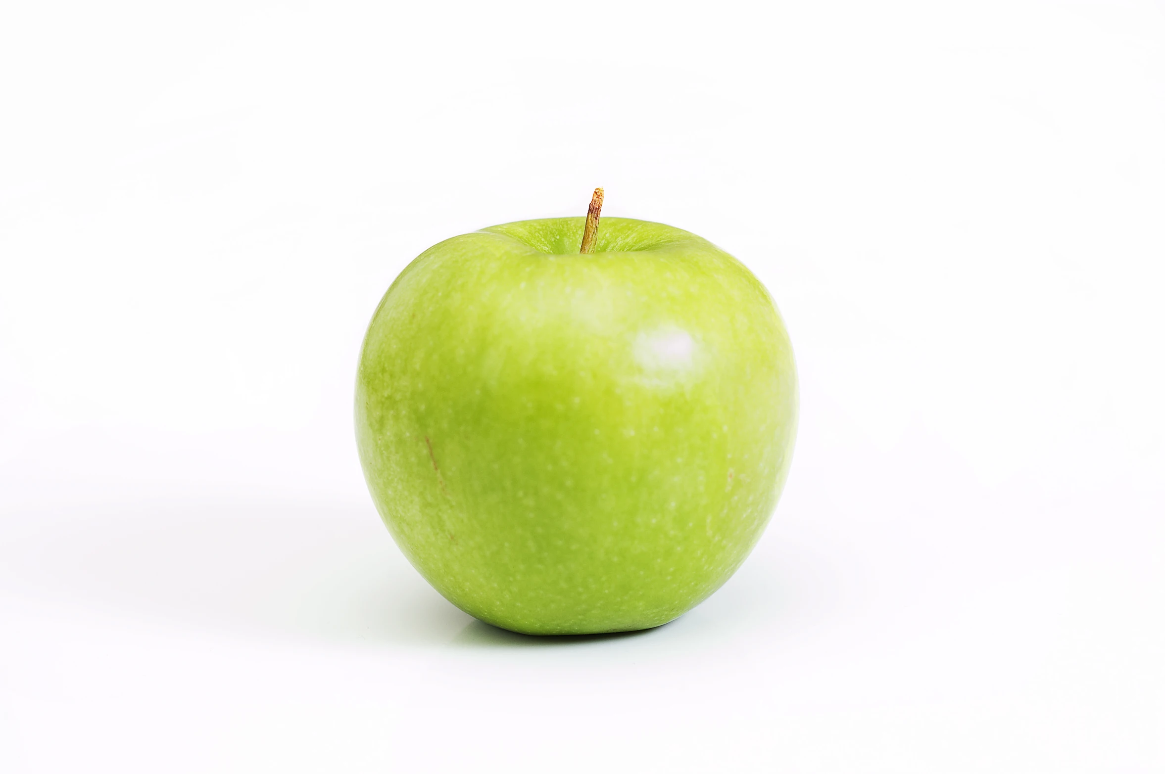 a bright green apple on a white background