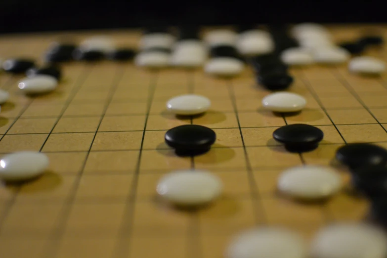 this is an abstract boardgame showing one player standing over several boards