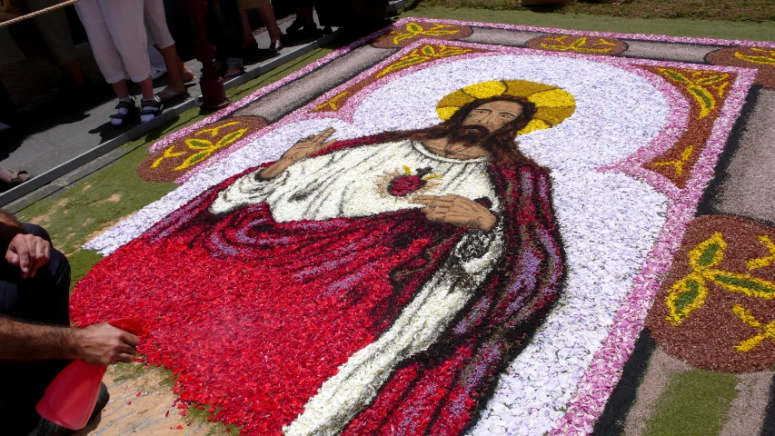 an image of jesus in flowers decorate the floor