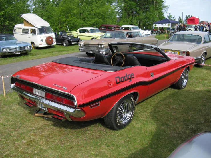 an old red and black car on display at a show