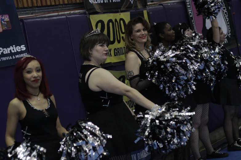 woman in cheerleader uniform doing tricks with pompoms