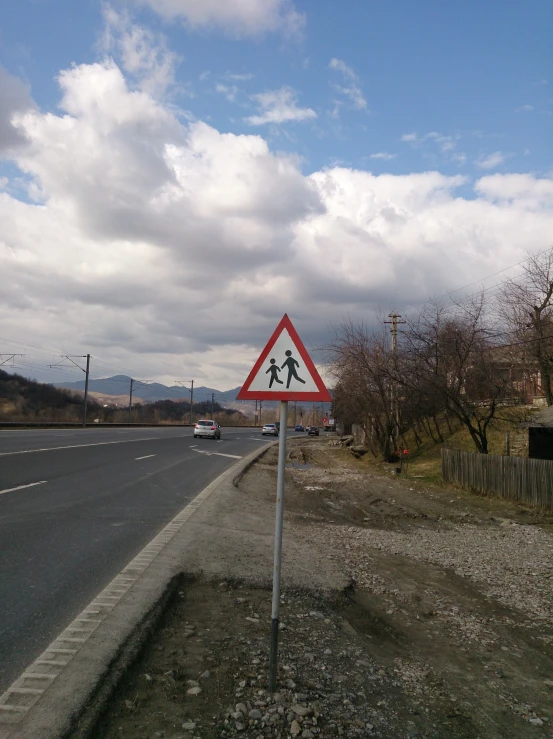 a street sign on a pole on the side of a road